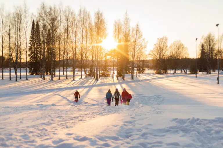 Ihmiset pulkkamäessä Joensuun Kirkkopuistossa
